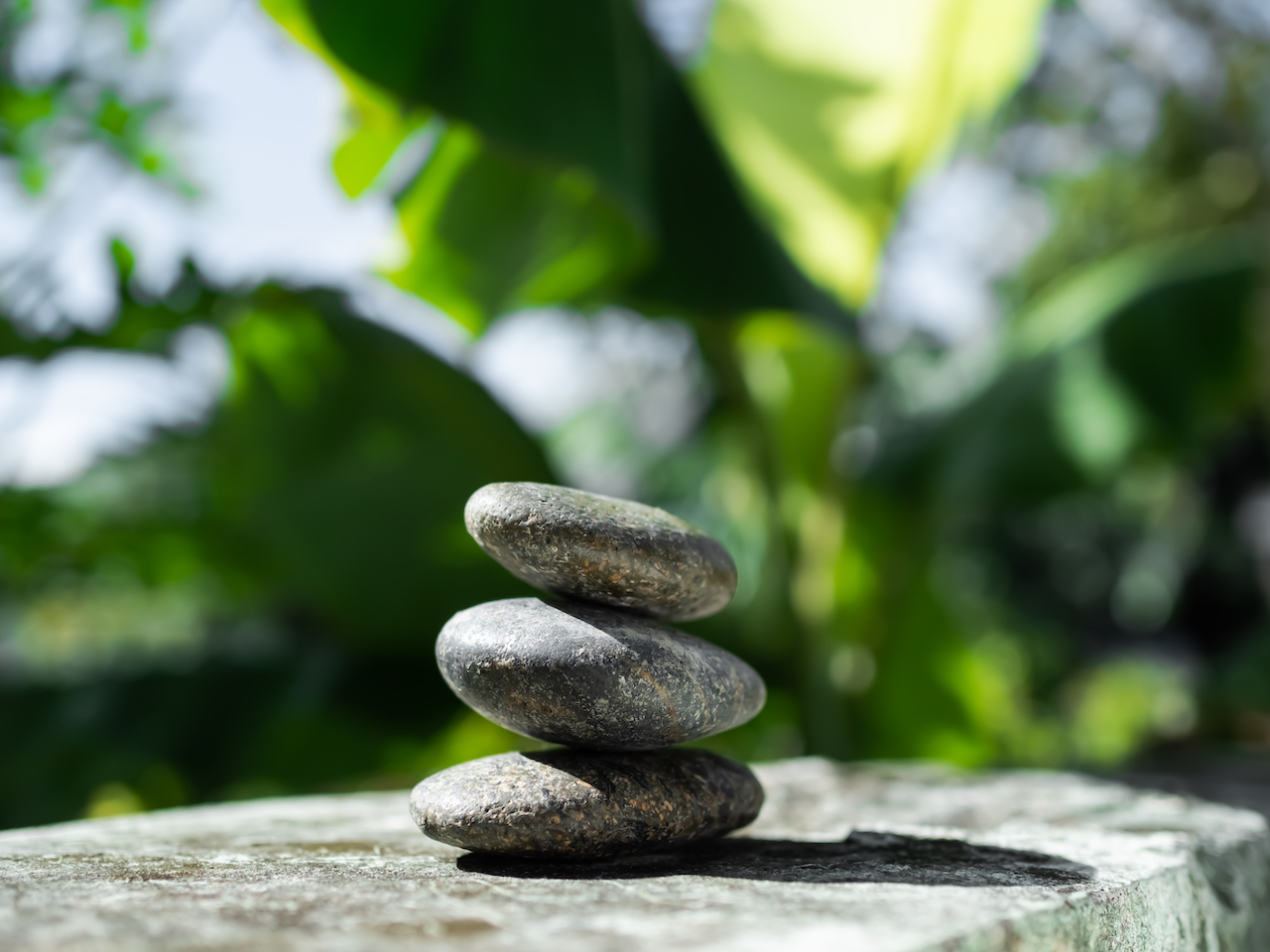 Stack Stone on cement Wall background.Pyramid Rock Cairn. Pebble SPiritual,Stability,Calm,Meditation Growth Symbols.Pile Zen Design Smooth for Vacation Relaxation Nature Aroma therapy Spa Concept.